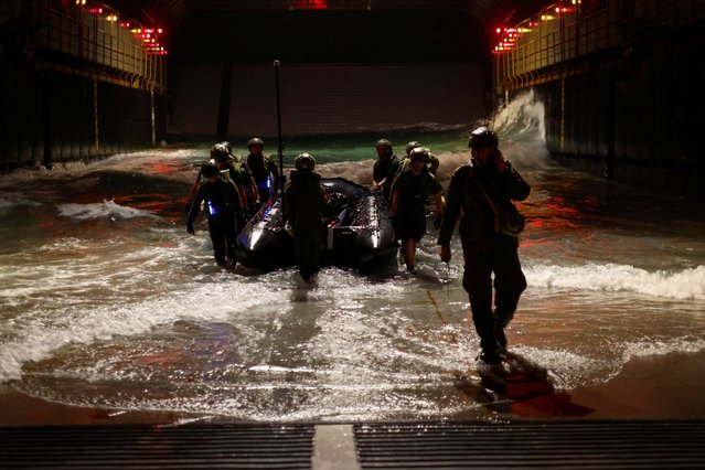 Soldiers with the Japanese Ground Self-Defense Force's Amphibious Rapid Deployment Brigade (ARDB), Japan's first marine unit since World War Two, use a semi-inflatable boat called a Combat Rubber Raid Craft (CRRC) as they take part in military training at the well deck inside the Japanese Maritime Self-Defense Force's amphibious transport ship JS Osumi (LST-4001), in waters close to Okinawa, Japan, November 14, 2023. Although Japan's Amphibious Rapid Deployment Brigade (ARDB) is expected to lead the way on the frontlines, their unit – and Japan's military – lag far behind in gender diversity, a problem that risks turning into a crisis as the country's greying population shrinks while threats from China, Russia and North Korea grow. (Photo by Issei Kato/Reuters)
