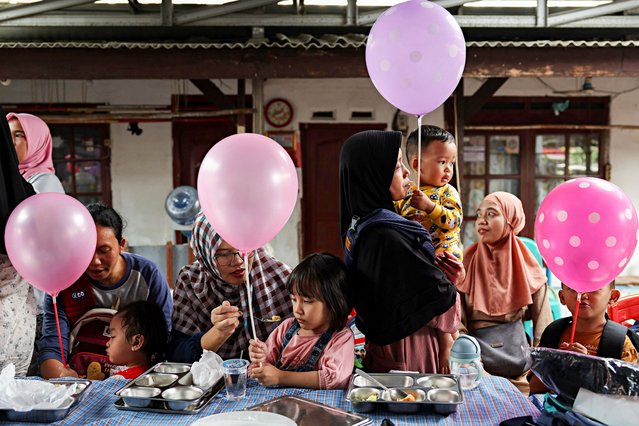 People carry balloons during the free nutritious meals program in Jakarta, Indonesia, on January 10, 2025. (Photo by Ajeng Dinar Ulfiana/Reuters)