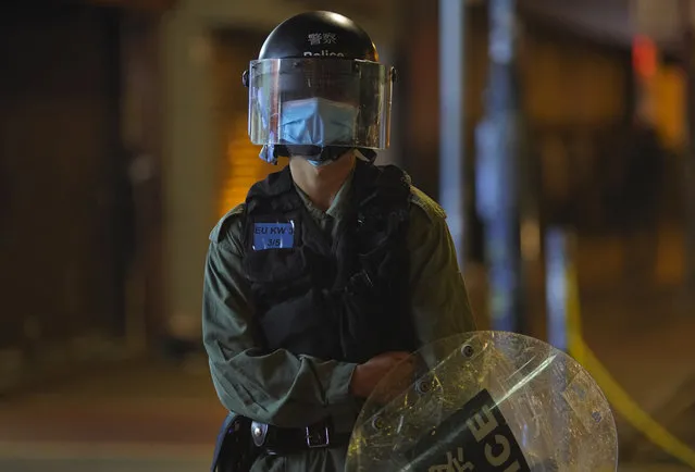 A police officer stand guard as more than 200 people were arrested during anti-government protests in Hong Kong early Monday, May 11, 2020. A pro-democracy movement that paralyzed Hong Kong for months last year has shown signs of reviving in recent weeks as the coronavirus threat eases. The government recently decided to allow public gatherings of eight people, up from four previously. (Photo by Vincent Yu/AP Photo)