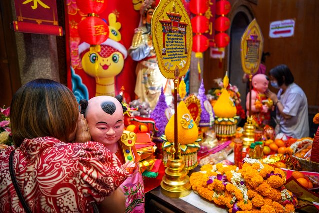 Women whisper to Chinese statues as they pray at a Chinese temple on Lunar New Year in Bangkok, Thailand, on January 29, 2025. (Photo by Athit Perawongmetha/Reuters)