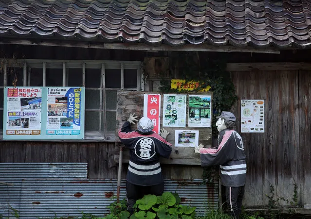 An illustration showing a scarecrow pasting posters on a village notice board at Kakashi no Sato, or the Scarecrow's Hometown on September 10, 2014 in Himeji, Japan. (Photo by Buddhika Weerasinghe/Getty Images)