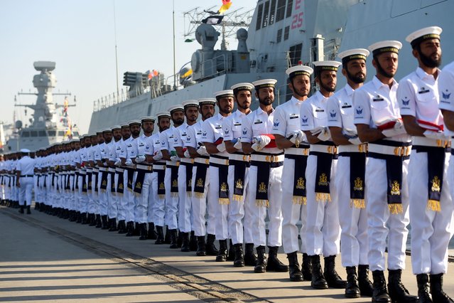 Pakistani navy carry flags of foreign countries participating during the multinational naval exercise AMAN-25 in Karachi on February 7, 2025. (Photo by Rizwan Tabassum/AFP Photo)