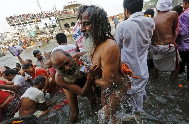 Sadhus or Hindu holy men take a dip in the waters of Godavari river during the second “Shahi Snan” (grand bath) at Kumbh Mela or Pitcher Festival in Nashik, India, September 13, 2015. (Photo by Adnan Abidi/Reuters)