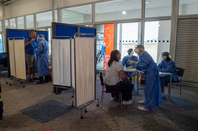 Medical staff conduct a test for the new coronavirus on the passengers who arrived from Doha to Eleftherios Venizelos International Airport in Athens on June 15, 2020 in Athens, Greece. The country removed most restrictions on travel from EU countries today in an effort to jumpstart its tourist season. Travelers from countries deemed high-risk, like the UK countries, will still face compulsory Covid-19 testing and mandatory quarantine. One week for a negative result; two weeks for a positive result. (Photo by Milos Bicanski/Getty Images)