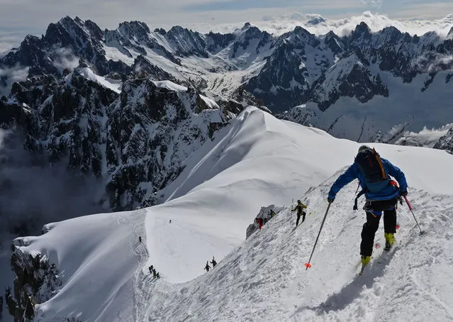 Mountaineers ski to the “Vallee Blanche” a glacial valley located in the Mont-Blanc massif, from the “Aiguille du Midi” peak in Chamonix, on May 16, 2020, on the first day of the reopening as France eases lockdown measures taken to curb the spread of the COVID-19 pandemic, caused by the novel coronavirus. (Photo by Philippe Desmazes/AFP Photo)