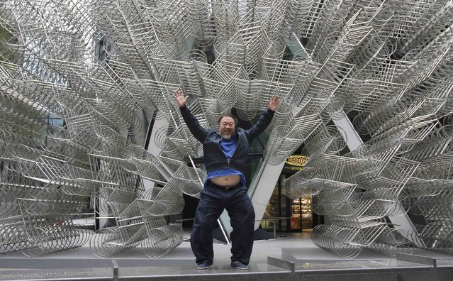 Artist Ai Weiwei visits his sculpture, “Forever”, recently installed in front of the “Gherkin” in the City of London, Britain, September 16, 2015. The artwork designed in 2014, forms part of “Sculpture in the City”, where contemporary artworks are placed in public areas. (Photo by Peter Nicholls/Reuters)