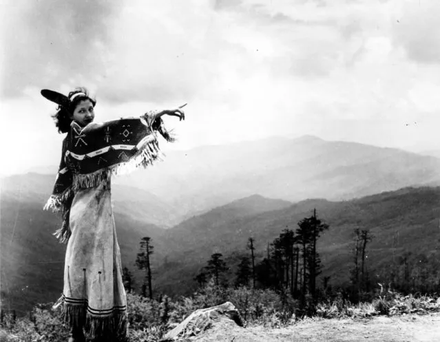 A Cherokee woman points to the rugged Smokey Mountains of North Carolina on November 30, 1942.  She is a graduate of a modern school and the granddaughter of a Cherokee Chief. (Photo by AP Photo)