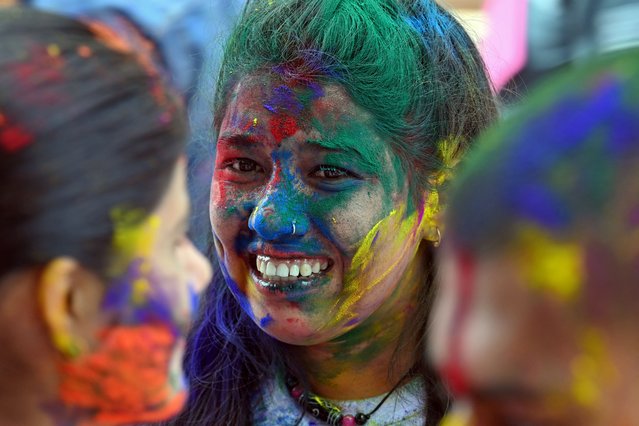Revellers play with coloured powders as they celebrate Holi, the Hindu spring festival of colours, in Kathmandu on March 13, 2025. (Photo by Prakash Mathema/AFP Photo)