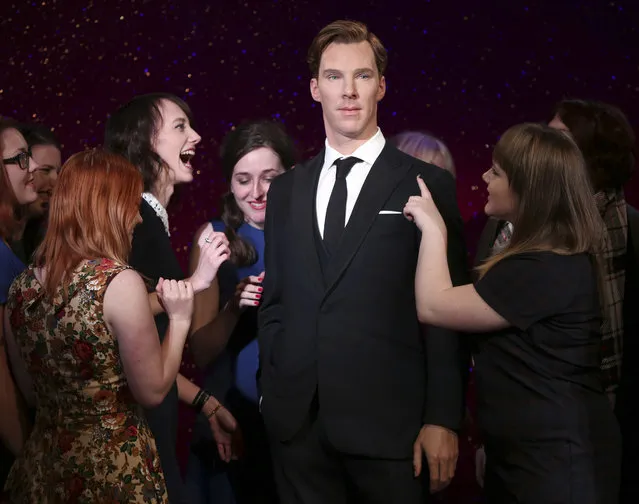 Fans gather around the new wax figure of Benedict Cumberbatch as it is unveiled at Madame Tussauds in central London, Tuesday, October 21, 2014. (Photo by Joel Ryan/Invision/AP Photo)