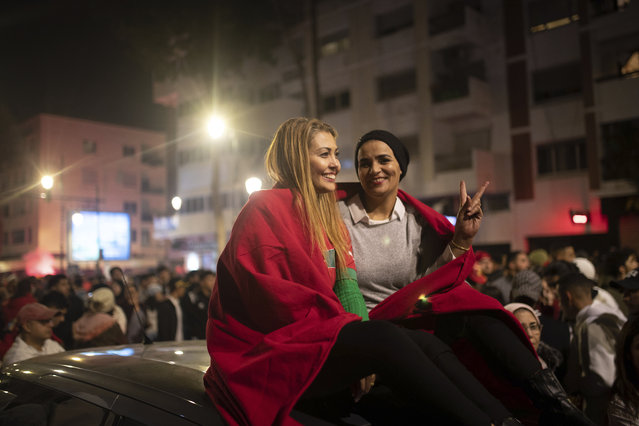 Moroccans gather to celebrate Morocco's win over Spain in a World Cup soccer match played in Qatar, in Rabat, Morocco, Tuesday, December 6, 2022. (Photo by Mosa'ab Elshamy/AP Photo)