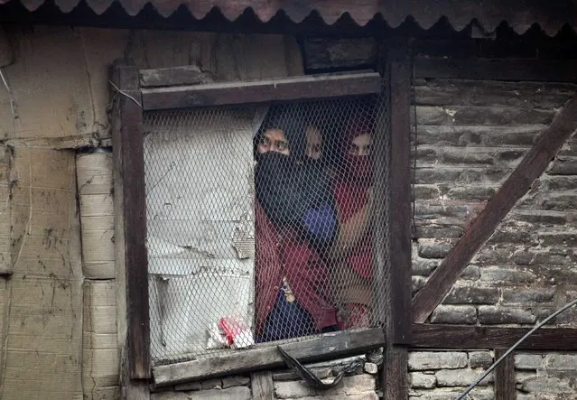 Kashmiri Muslim women watch a a Muharram procession a day before Ashoura in Srinagar November 3, 2014. (Photo by Danish Ismail/Reuters)