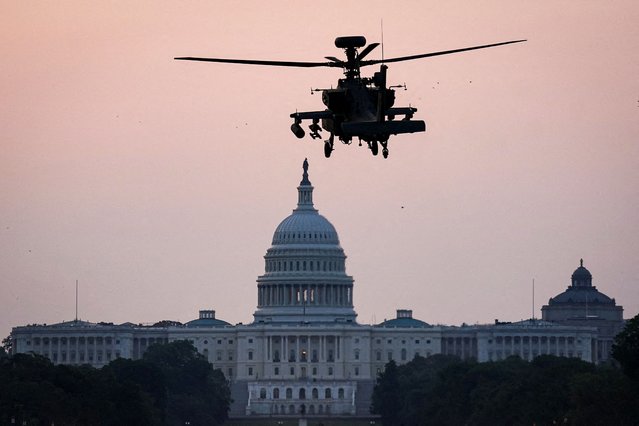 A Boeing AH-64 Apache attack helicopter to be used in the U.S. Army's 250th Birthday Celebration and Parade, prepares to land on the National Mall near the U.S. Capitol in Washington, D.C., June 11, 2025. (Photo by Al Drago/Reuters)