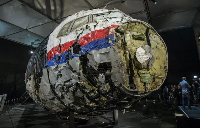 The reconstructed wreckage of the MH17 airplane is seen after the presentation of the final report into the crash of July 2014 of Malaysia Airlines flight MH17 over Ukraine, in Gilze Rijen, the Netherlands, October 13, 2015. Malaysian Airlines Flight 17 was shot down over eastern Ukraine by a Russian-made Buk missile, the Dutch Safety Board said on Tuesday in its final report on the July 2014 crash that killed all 298 aboard. (Photo by Michael Kooren/Reuters)