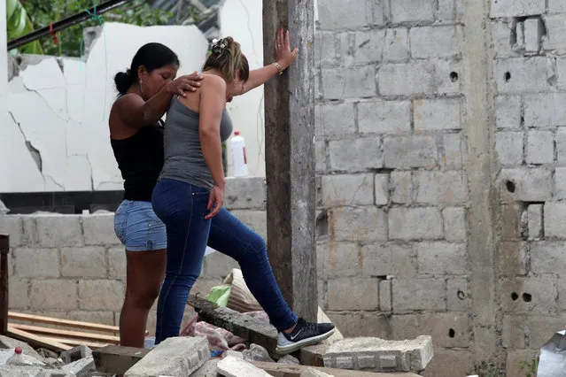 Women react outside their damaged home next to the scene of a bomb explosion at a police station in San Lorenzo, Ecuador January 27, 2018. (Photo by Daniel Tapia/Reuters)