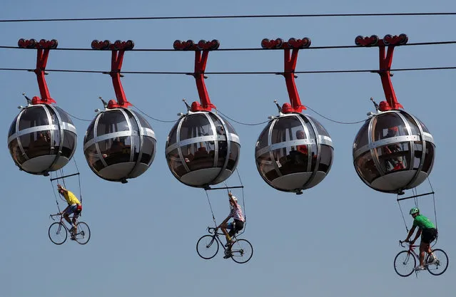 Performers dressed as riders pedal during the start of the stage 17 of the Tour de France cycling race over 170 kilometers (105 miles), with start in Grenoble and finish in Meribel Col de la Loze, Wednesday, September 16, 2020. (Photo by Stephane Mahe/Reuters)