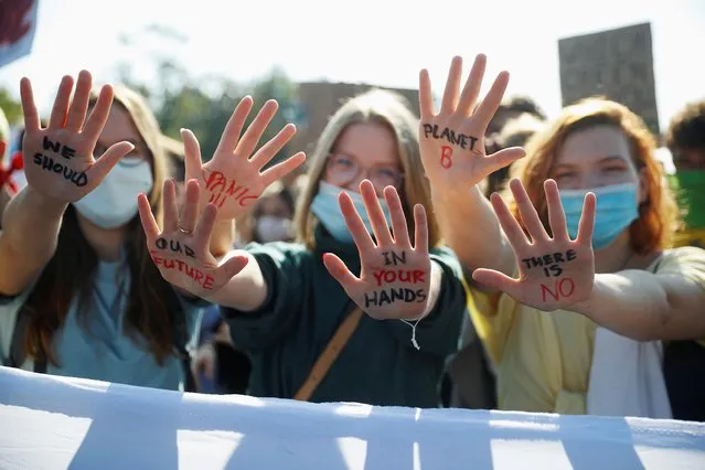 Women gesture as Fridays for Future activists protest calling for a “Global Day of Climate Action” in Warsaw, Poland, September 25, 2020. (Photo by Kacper Pempel/Reuters)