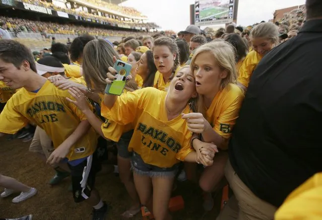 Baylor students run off the field after the pregame line up before an NCAA college football game against Oklahoma State Saturday, September 24, 2016, in Waco, Texas. (Photo by L.M. Otero/AP Photo)