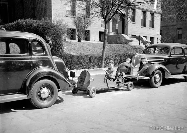 “Washington, D.C., March 30. Transportation and no parking worries. Nelm Clark, 16-year old Washington youngster, solved this problem by combining a lawn mower motor with a set of motor cycle gears to make this unusual midget auto. Costing $60 to build the contraption weighs only 150 pounds – the weight is its main feature – and if you run out of gas you easily push it or tuck it under your arm and walk home, 3/30/1937”. Photographed by Harris & Ewing.