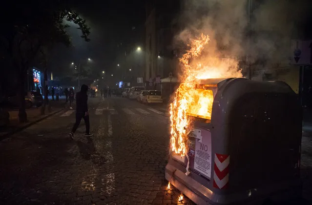 A garbage can set on fire during the clashes to protest against the lockdown on October 23, 2020 in Naples, Italy. (Photo by Ivan Romano/Getty Images)