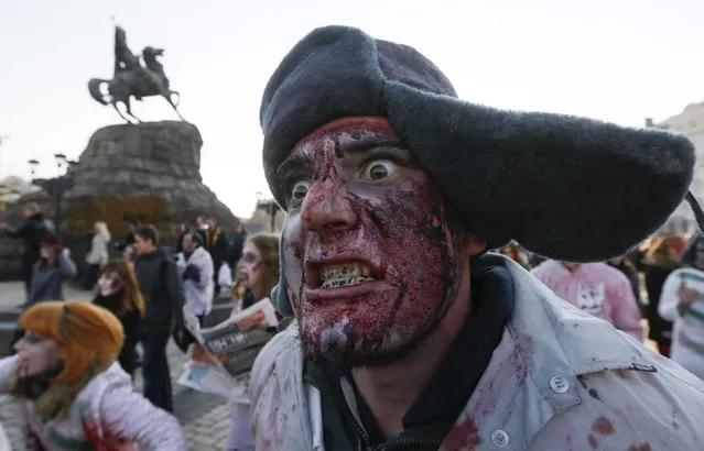 Revellers take part in a zombie parade to celebrate Halloween in Kiev, Ukraine, October 31, 2015. (Photo by Valentyn Ogirenko/Reuters)