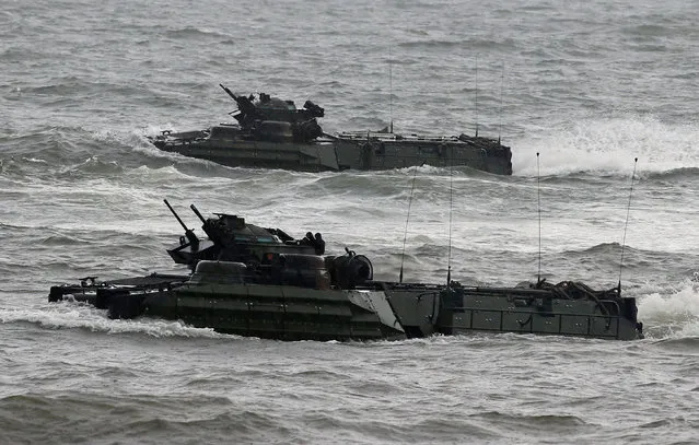 U.S. military forces aboard Amphibious Assault Vehicles (AAV) manoeuvre on South China Sea near the shore during the annual Philippines-US amphibious landing exercise (PHIBLEX) in San Antonio, Zambales province, Philippines October 7, 2016. (Photo by Romeo Ranoco/Reuters)
