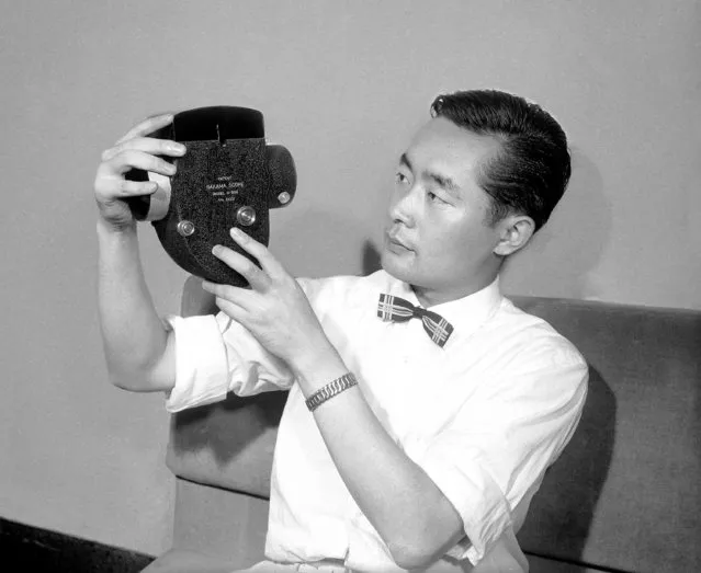 Yoshiro Nakamatsu, 29, president of the Tokyo University Inventor Society – with his invention for the movie industry, which, attached to a standard film projector, tailors the size of the screen to meet the needs of each scene. Nakamatsu's invention attaches to a standard projector, automatically controlling width of picture projection in Tokyo on September 9, 1957. (Photo by Mitsunori Chigita/AP Photo)