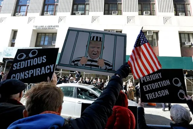 Demonstrators shout and hold up signs outside New York Criminal Court in advance of a potential Indictment of former President Donald Trump in New York, New York, USA, 21 March 2023. Major US News organizations continue to report the likelihood that former President Donald J. Trump may be the first US President to be formally indicted on charges related to hush-money payments to p*rn star Stormy Daniels. (Photo by Peter Foley/EPA/EFE/Rex Features/Shutterstock)