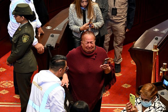A woman mourns as she pays homage to slain Colombian presidential candidate Miguel Uribe as his body lies in state at Congress in Bogota on August 12, 2025. Colombian presidential candidate Miguel Uribe died two months after being shot in the head at a campaign event, his wife announced early August 11, 2025, as the attack rekindled fears of a return to the nation's violent past. (Photo by Raul Arboleda/AFP Photo)