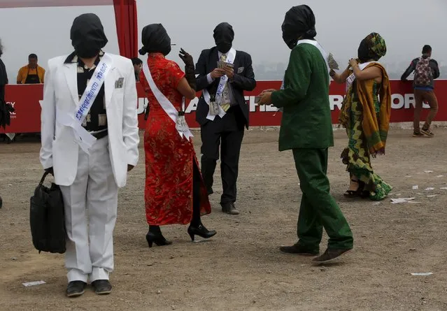 Actors portraying "corrupted people" participate in the "Unmask the Corrupt" event, organized by the Transparency International non-governmental organization to create awareness on corruption, in Lima, November 12, 2015. (Photo by Mariana Bazo/Reuters)