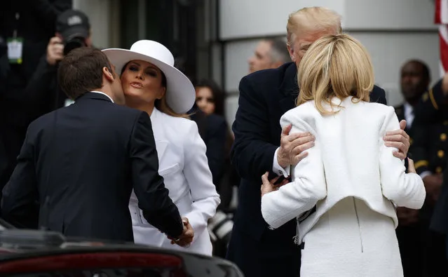 First lady Melania Trump greets French President Emmanuel Macron, left, and President Donald Trump greets Brigitte Macron, right, as they arrive for a State Arrival Ceremony on the South Lawn of the White House in Washington, Tuesday, April 24, 2018. (Photo by Carolyn Kaster/AP Photo)