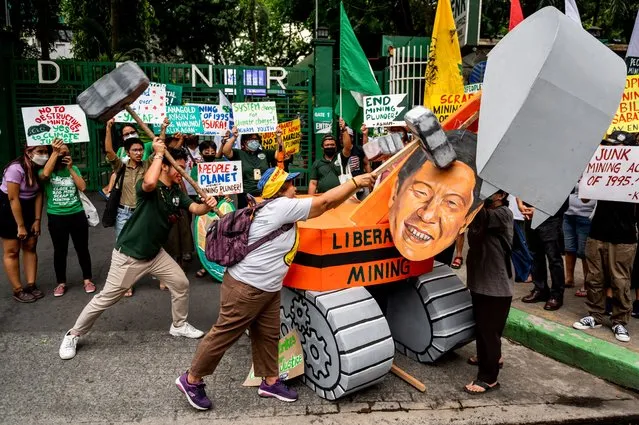 Climate activists destroy an image of Philippine President Ferdinand Marcos Jr. and a mockup of an excavator used for mining, during a Global Climate Strike protest in Quezon City, Metro Manila, Philippines on March 3, 2023. (Photo by Lisa Marie David/Reuters)