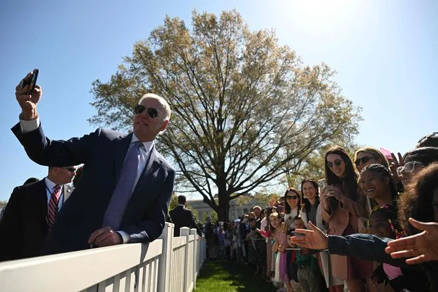US President Joe Biden takes a selfie with guests at the annual Easter Egg Roll on the South Lawn of the White House in Washington, DC, on April 10, 2023. The theme of this year's Easter Egg Roll is “EGGucation”. (Photo by Andrew Caballero-Reynolds/AFP Photo)