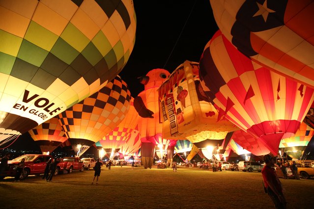 This view shows giant hot air balloons being inflated during the 2025 International Balloon Festival (FIG) in Leon, Mexico on November 14, 2025. (Photo by Mario Armas/AFP Photo)