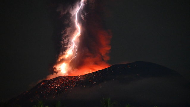A handout photo made available by Indonesia's Center for Volcanology and Geological Hazard Mitigation shows volcanic lightning during an eruption from Mount Ibu in North Maluku province, Indonesia, 04 July 2024. The Center for Volcanology and Geological Disaster Mitigation (PVMBG) advises the community around Mount Ibu and visitors not to carry out activities within a radius of 2.0 kilometers and a sectoral expansion of 5 kilometers towards the crater opening in the northern part of the active crater of Mount Ibu. (Photo by PVMBG/EPA)