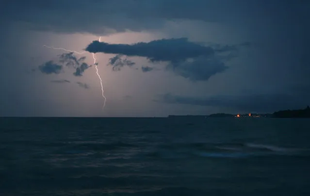 A photo made available 10 August 2015 of a ligthning striking and illuminating the sky over Lake Constance, near Lindau, Germany, 09 August 2015. (Photo by Karl-Josef Hildenbrand/EPA)