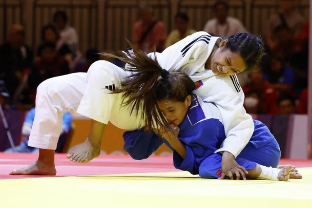 Cambodia's Kun Sreynich and Philippines' Lopez Leah in action during individual judo finals at Chroy Changvar Convention Centre Hall C in Phnom Penh, Cambodia on May 15, 2023. (Photo by Kim Kyung-Hoon/Reuters)