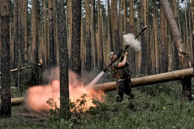 A Ukrainian soldier fires an RPG toward Russian positions at the frontline near Kremenna in the Luhansk region, Ukraine, Tuesday, May 9, 2023. (Photo by LIBKOS/AP Photo)