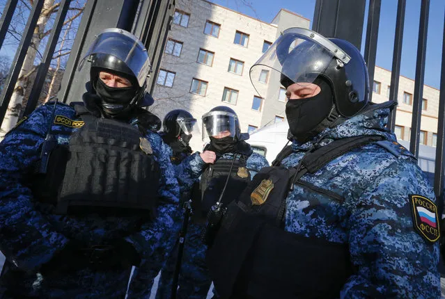 Russian Federal Bailiffs service officers stand guard at the Babushkinsky district court prior to the start of the trial against Russian opposition leader Alexey Navalny in Moscow, Russia, Tuesday, February 16, 2021. Moscow court continue the trial against Russian opposition leader Alexey Navalny on the charges of defamation. Navalny was accused of slandering a World War II veteran featured in the video promoting the constitutional reform allowing to extend President Vladimir Putin's rule. The politician slammed people in the video as “traitors” and stands trial on defamation charges. (Photo by Alexander Zemlianichenko/AP Photo)