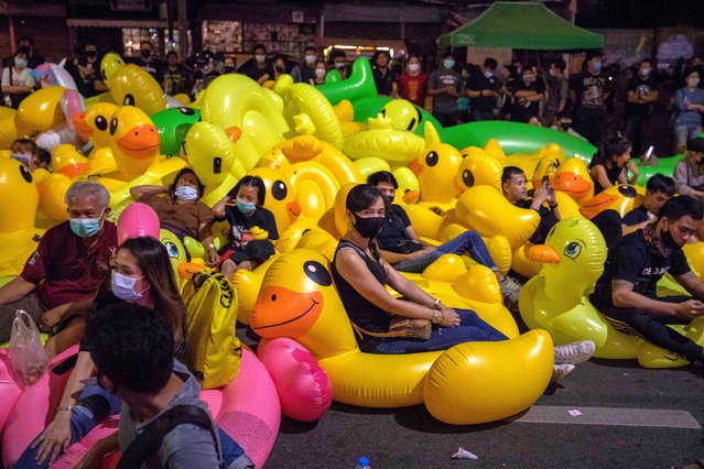 Pro-democracy protesters sit on rubber ducks during a rally on December 02, 2020 in Bangkok, Thailand. Pro-democracy protesters held a rally at the Ladprao intersection in Bangkok as part of a series of actions that have kept the pressure up on the Thai government. (Photo by Lauren DeCicca/Getty Images)