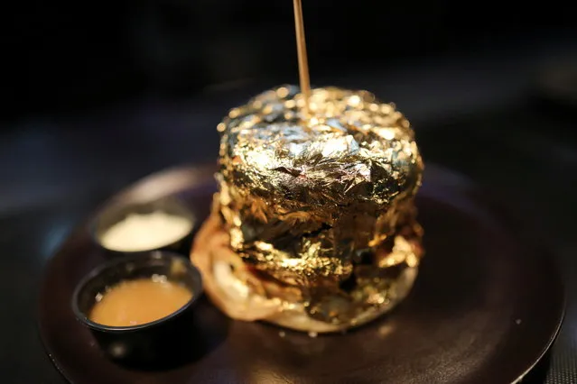 A burger covered with gold foil is seen inside the Toro McCoy restaurant, in Bogota, Colombia on December 18, 2020. (Photo by Luisa Gonzalez/Reuters)
