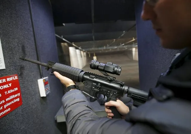 Alec Murrary holds an AR-15 assault rifle at the Ringmasters of Utah gun range, in Springville, Utah on December 18, 2015. (Photo by George Frey/Reuters)