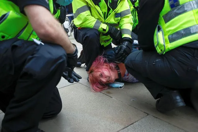 Police officers detain a demonstrator during a protest against a new proposed policing bill, in Manchester, Britain, March 27, 2021. (Photo by Phil Noble/Reuters)