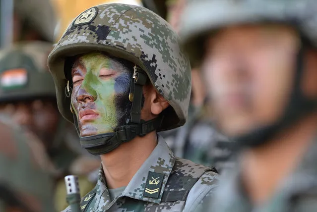 A People's Liberation Army (PLA) of China soldier looks on after participating in an anti-terror drill during the Sixth India-China Joint Training exercise “Hand in Hand 2016” at HQ 330 Infantry Brigade, in Aundh in Pune district, some 145km southeast of Mumbai, on November 25, 2016. (Photo by Indranil Mukherjee/AFP Photo)