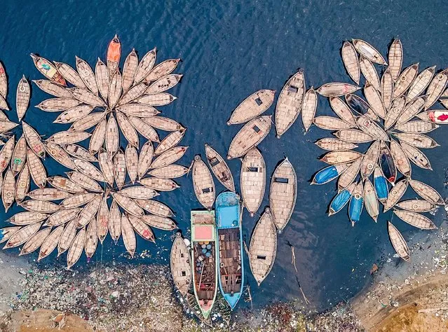 The boats are seen fanned out on the Buriganga River in Dhaka, Bangladesh early July 2023. (Photo by Muhammad Amdad Hossain/Solent News & Photo Agency)