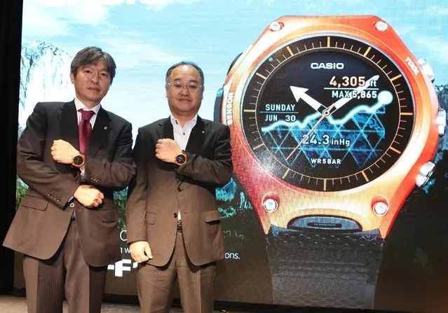 Kazuhiro Kashio and Shunji Minami show off Casio's new Smart Outdoor Watch at its press conference at Mandalay Bay in Las Vegas during CES 2016 on January 5, 2016. (Photo by Bizuayehu Tesfaye/Invision for Casio/AP Images)