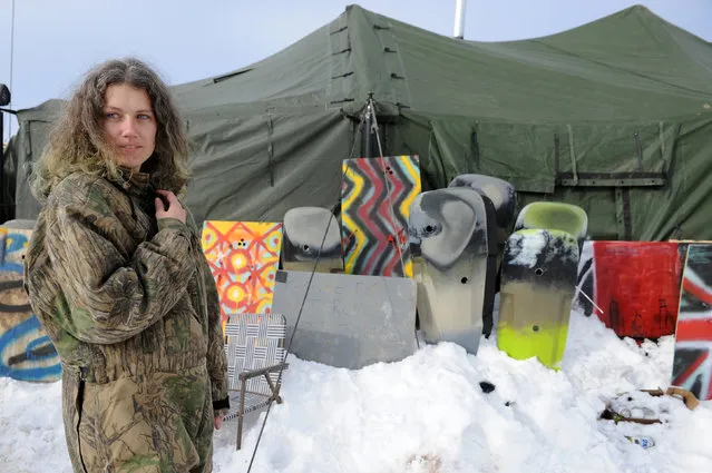 A veteran stands in front of homemade shields in Oceti Sakowin camp as “water protectors” continue to demonstrate against plans to pass the Dakota Access pipeline near the Standing Rock Indian Reservation, near Cannon Ball, North Dakota, U.S. December 3, 2016. (Photo by Stephanie Keith/Reuters)