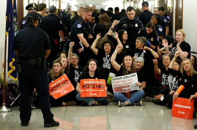 Demonstrators chant before being arrested as they protest against U.S. Supreme Court nominee Brett Kavanaugh in front of the office of Senator Susan Collins (R-ME) on Capitol Hill in Washington, U.S., September 24, 2018. (Photo by Joshua Roberts/Reuters)