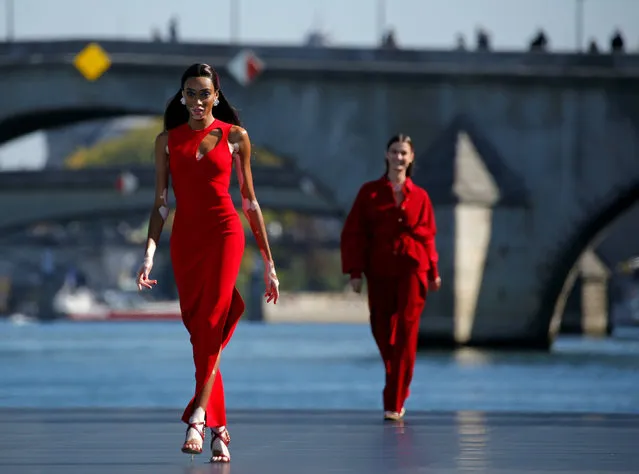 Model Winnie Harlow presents a creation on a giant catwalk installed on a barge on the Seine River during a public event organized by French cosmetics group L'Oreal as part of Paris Fashion Week, France, September 30, 2018. (Photo by Stephane Mahe/Reuters)