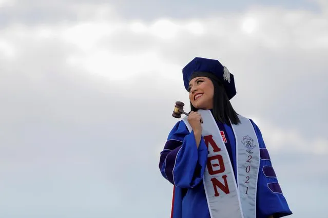 Sandy Arce, 29, holds a gavel during a photoshoot to celebrate her graduation from the American University Washington College of Law in Washington, May 14, 2021. (Photo by Andrew Kelly/Reuters)