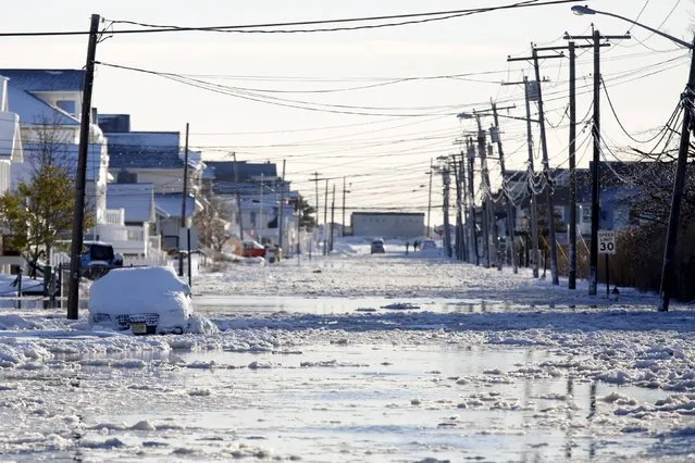 Floodwaters cover Brielle Road after a winter storm in Manasquan, New Jersey, January 24, 2016. A morning high tide surge of 2 feet followed snowfall of about 2 feet in the first major storm of the season. (Photo by Dominick Reuter/Reuters)